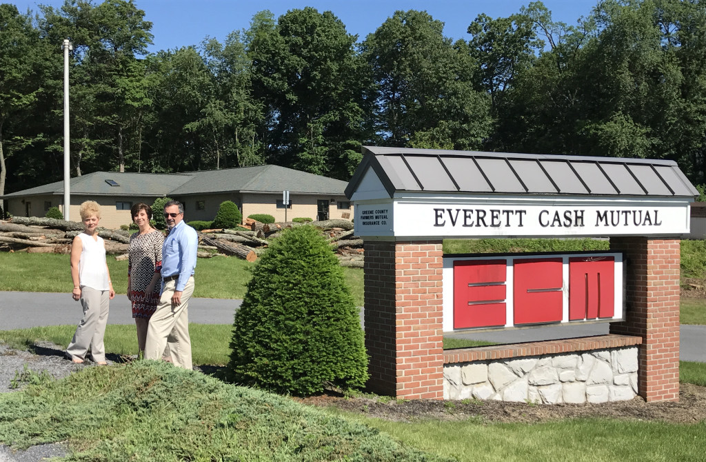 Everett Cash Mutual is renovating the former police barracks -in background- located adjacent to the ECM home office to accomodate the company's growth. (l-r) Bridget Glass, Executive Vice President, ECM Service Agency, Sharon Waltman, Information Systems Supervisor and Randy Shaw, President/CEO Everett Cash Mutual Ins. Co. 